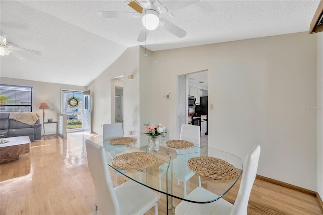 3302 69th St W, Bradenton, FL 34209 - dining area with a ceiling fan, vaulted ceiling, wood finished floors, and a textured ceiling