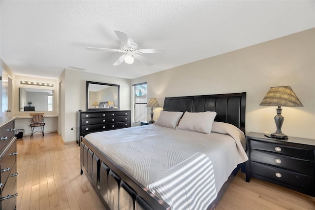 3302 69th St W, Bradenton, FL 34209 - bedroom with light wood-style flooring, ceiling fan, and a textured ceiling