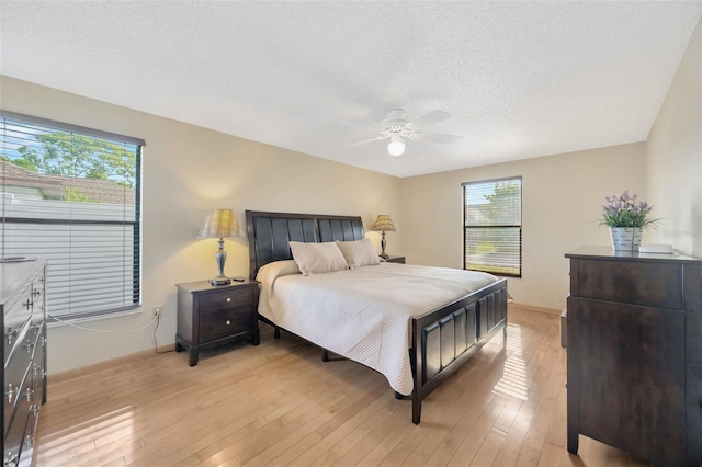 3302 69th St W, Bradenton, FL 34209 - bedroom featuring light wood-style flooring, a textured ceiling, and a ceiling fan