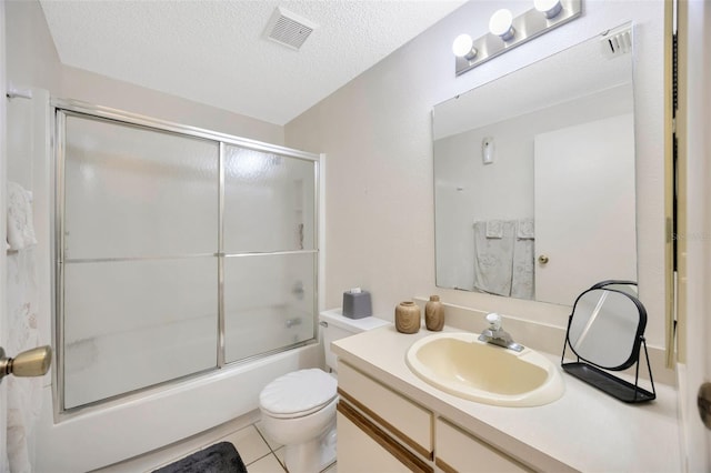 3302 69th St W, Bradenton, FL 34209 - bathroom with vanity, enclosed tub / shower combo, a textured ceiling, and tile patterned floors