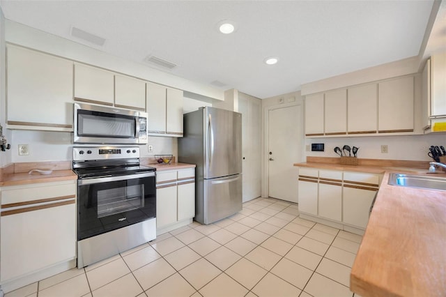 3302 69th St W, Bradenton, FL 34209 - kitchen with appliances with stainless steel finishes, light countertops, light tile patterned flooring, and recessed lighting
