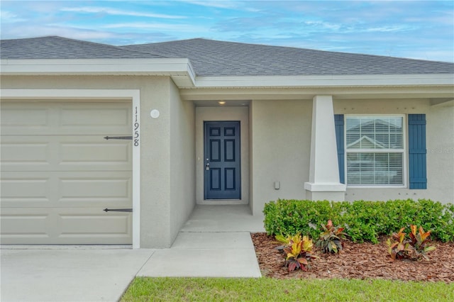 11958 Stone Pine St, Riverview, FL 33569 - property entrance with a garage, roof with shingles, and stucco siding