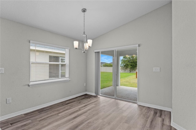 11958 Stone Pine St, Riverview, FL 33569 - unfurnished room featuring wood finished floors, a chandelier, and lofted ceiling