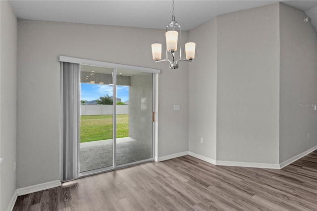 11958 Stone Pine St, Riverview, FL 33569 - unfurnished dining area with wood finished floors and a chandelier