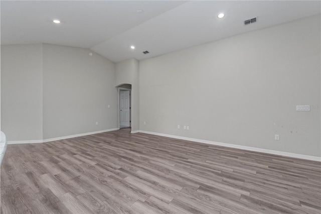 11958 Stone Pine St, Riverview, FL 33569 - unfurnished room featuring arched walkways, wood finished floors, recessed lighting, and vaulted ceiling