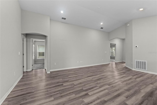 11958 Stone Pine St, Riverview, FL 33569 - unfurnished room with arched walkways, high vaulted ceiling, wood finished floors, and recessed lighting