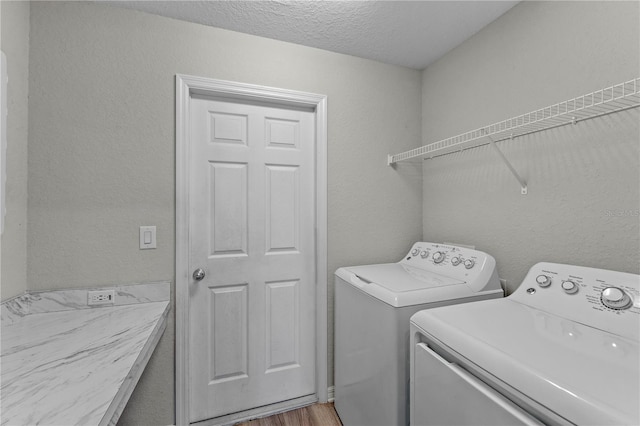 11958 Stone Pine St, Riverview, FL 33569 - washroom with washing machine and dryer, wood finished floors, a textured ceiling, and a textured wall
