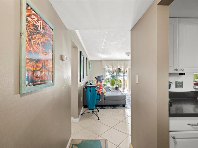 464 N Paula Dr Unit 106, Dunedin, FL 34698 - hallway featuring light tile patterned floors and baseboards
