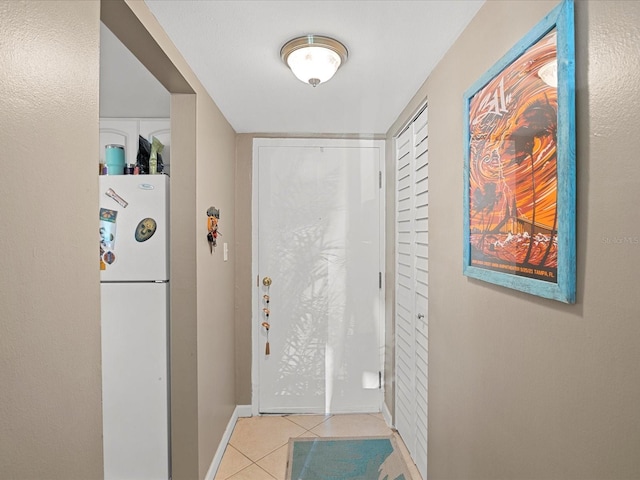 464 N Paula Dr Unit 106, Dunedin, FL 34698 - entryway with light tile patterned floors and baseboards