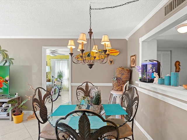 464 N Paula Dr Unit 106, Dunedin, FL 34698 - dining room featuring light tile patterned floors, a textured ceiling, a chandelier, and crown molding