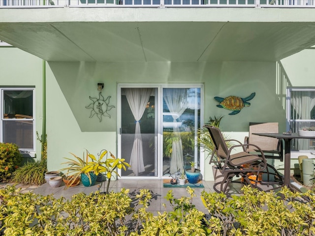 464 N Paula Dr Unit 106, Dunedin, FL 34698 - exterior space featuring stucco siding and a patio area