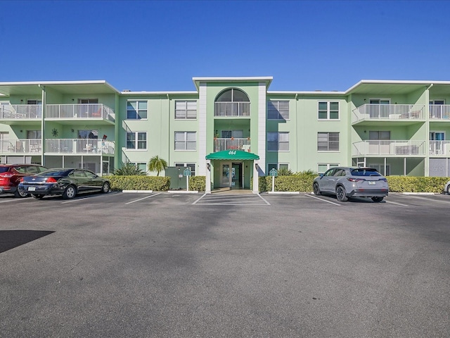464 N Paula Dr Unit 106, Dunedin, FL 34698 - view of apartment building / complex with uncovered parking