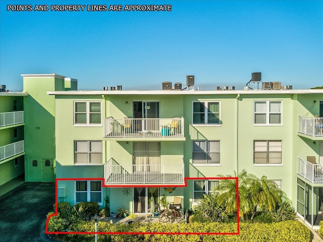 464 N Paula Dr Unit 106, Dunedin, FL 34698 - back of house featuring stucco siding
