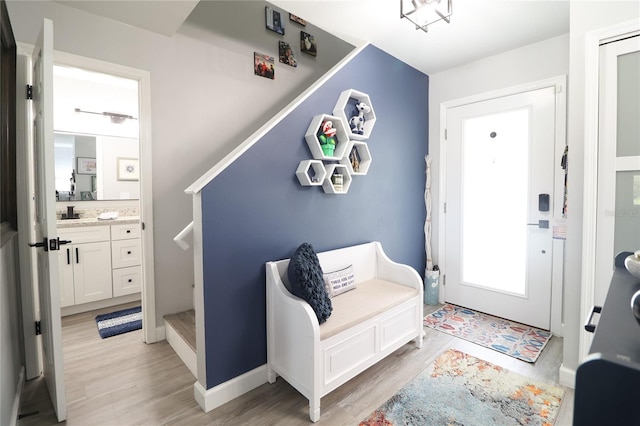 72 Pine Island Cir, Kissimmee, FL 34743 - entrance foyer with light wood-style flooring and stairway