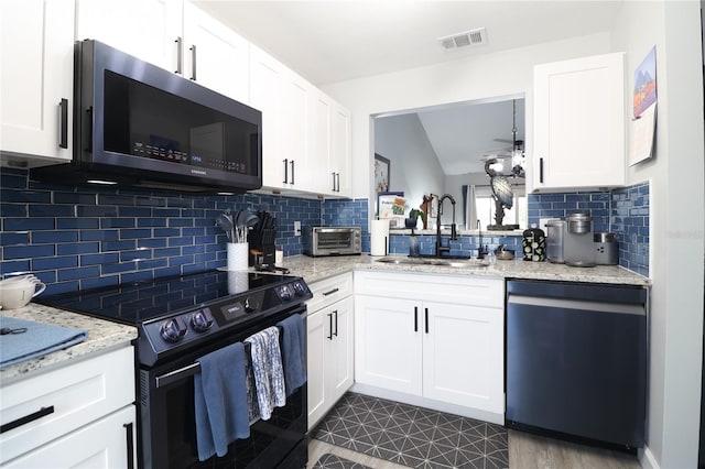 72 Pine Island Cir, Kissimmee, FL 34743 - kitchen featuring dishwasher, black range with electric stovetop, decorative backsplash, and white cabinets
