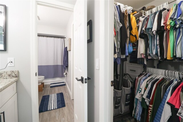 72 Pine Island Cir, Kissimmee, FL 34743 - walk in closet featuring wood finished floors