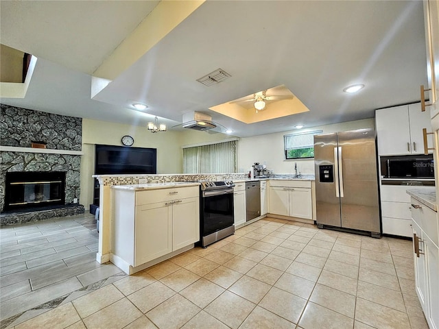 10928 Echo Loop, New Port Richey, FL 34654 - kitchen featuring stainless steel appliances, ceiling fan, light countertops, a peninsula, and open floor plan