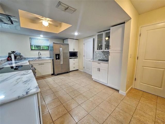 10928 Echo Loop, New Port Richey, FL 34654 - kitchen with stainless steel fridge, black microwave, light tile patterned flooring, stove, and recessed lighting