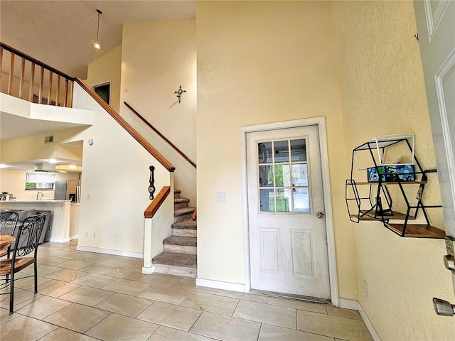 10928 Echo Loop, New Port Richey, FL 34654 - entrance foyer featuring a towering ceiling, stairs, and light tile patterned floors