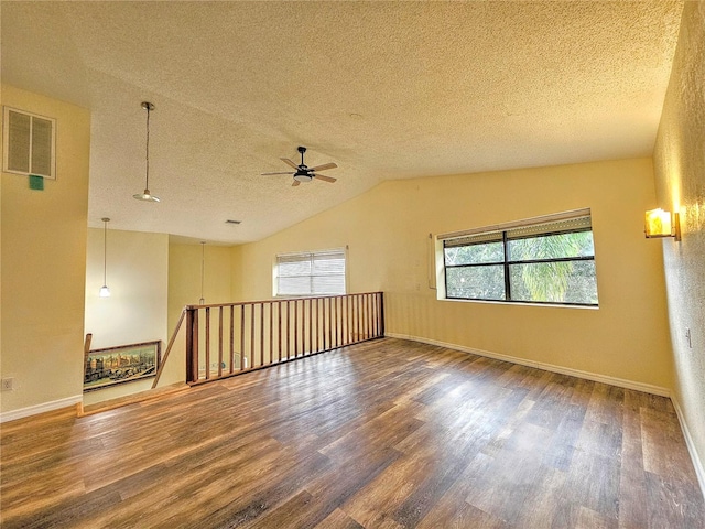 10928 Echo Loop, New Port Richey, FL 34654 - empty room featuring wood finished floors, a textured ceiling, a ceiling fan, and vaulted ceiling