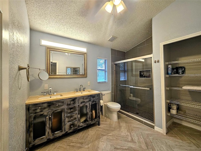 10928 Echo Loop, New Port Richey, FL 34654 - bathroom featuring a stall shower, double vanity, lofted ceiling, a ceiling fan, and a textured ceiling