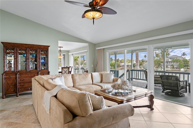 131 N Tessier Dr, St Pete Beach, FL 33706 - living area with vaulted ceiling, a ceiling fan, and light tile patterned floors