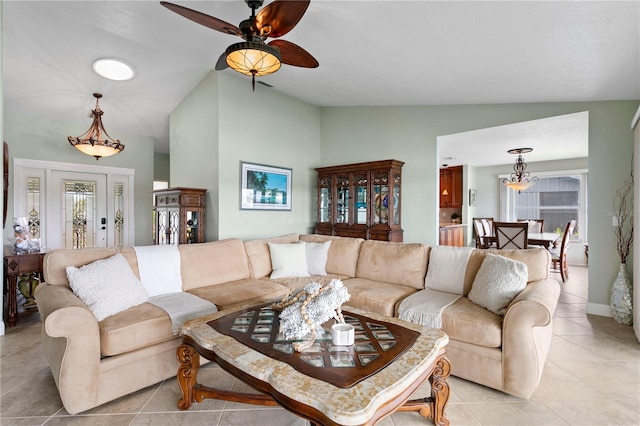 131 N Tessier Dr, St Pete Beach, FL 33706 - living area with vaulted ceiling, light tile patterned flooring, and a ceiling fan