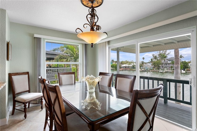 131 N Tessier Dr, St Pete Beach, FL 33706 - dining space with a water view and light tile patterned flooring