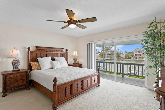 131 N Tessier Dr, St Pete Beach, FL 33706 - carpeted bedroom with access to outside, a ceiling fan, and a water view