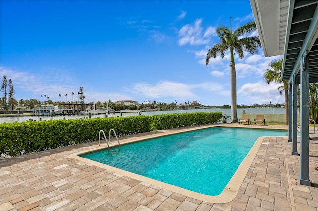 131 N Tessier Dr, St Pete Beach, FL 33706 - swimming pool featuring a water view and a patio area