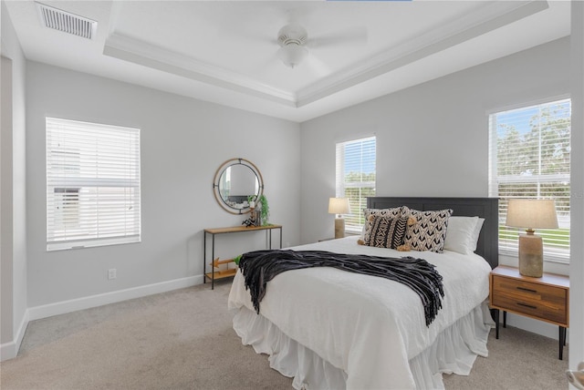 527 Jetstar Ln, Oldsmar, FL 34677 - carpeted bedroom featuring a tray ceiling, crown molding, and a ceiling fan