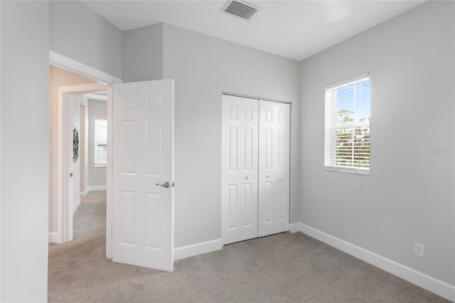 527 Jetstar Ln, Oldsmar, FL 34677 - unfurnished bedroom with light carpet and a closet