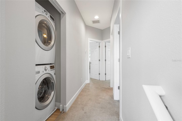 527 Jetstar Ln, Oldsmar, FL 34677 - washroom featuring stacked washing machine and dryer and light carpet