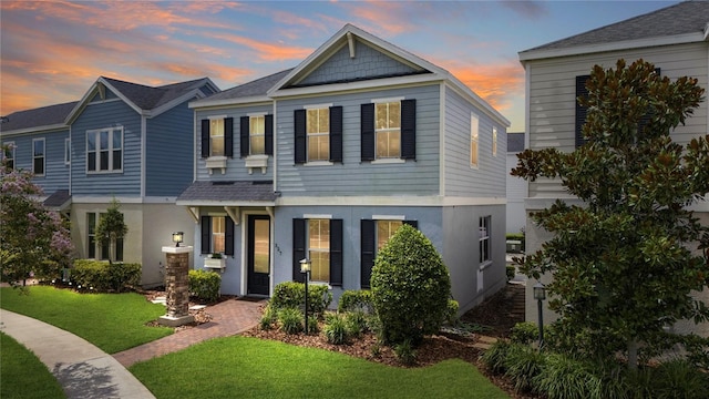 527 Jetstar Ln, Oldsmar, FL 34677 - view of front facade featuring stucco siding, a front lawn, and a shingled roof