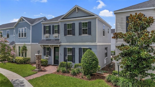 527 Jetstar Ln, Oldsmar, FL 34677 - view of front of property with a front yard, stucco siding, and roof with shingles