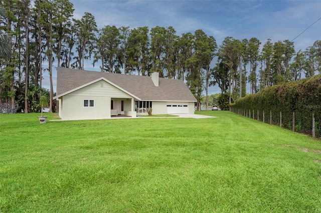 19410 N 41st Hwy, Lutz, FL 33548 - back of property featuring a yard, an attached garage, a chimney, and a shingled roof
