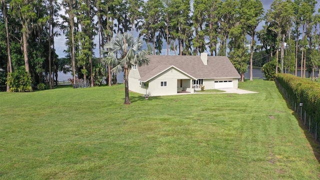19410 N 41st Hwy, Lutz, FL 33548 - back of house with a water view, an attached garage, a chimney, and a shingled roof