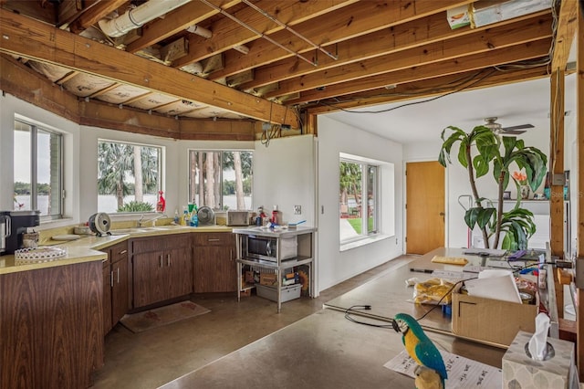 19410 N 41st Hwy, Lutz, FL 33548 - kitchen featuring finished concrete flooring, healthy amount of natural light, light countertops, and a ceiling fan