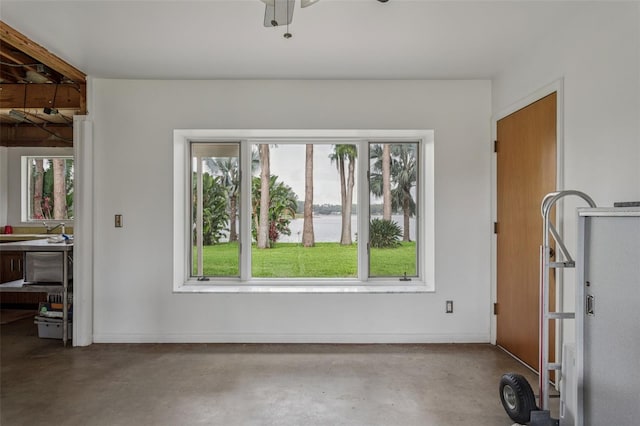 19410 N 41st Hwy, Lutz, FL 33548 - unfurnished dining area featuring plenty of natural light, concrete flooring, a water view, and a ceiling fan