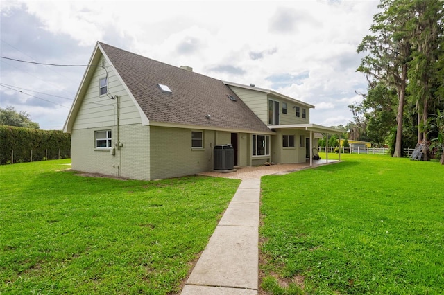 19410 N 41st Hwy, Lutz, FL 33548 - rear view of property featuring a shingled roof, brick siding, a yard, and a patio