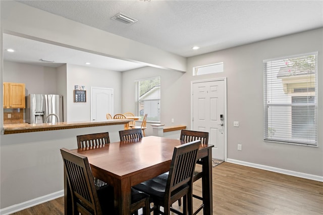 4715 Barnstead Dr, Riverview, FL 33578 - dining room featuring wood finished floors, recessed lighting, and a textured ceiling