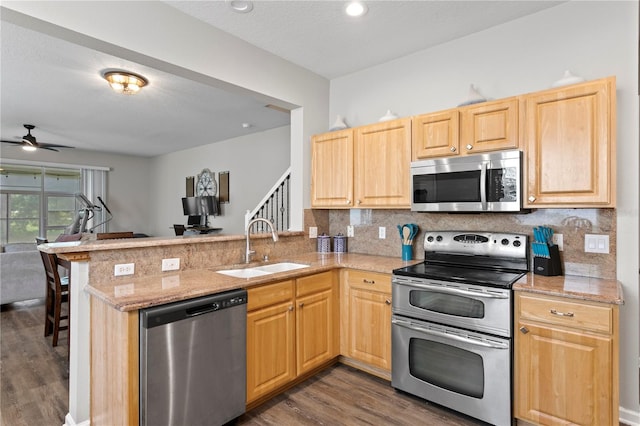 4715 Barnstead Dr, Riverview, FL 33578 - kitchen with stainless steel appliances, dark wood-type flooring, a peninsula, light brown cabinets, and a ceiling fan