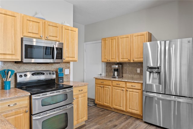 4715 Barnstead Dr, Riverview, FL 33578 - kitchen featuring stainless steel appliances, light brown cabinets, decorative backsplash, dark wood finished floors, and light stone countertops