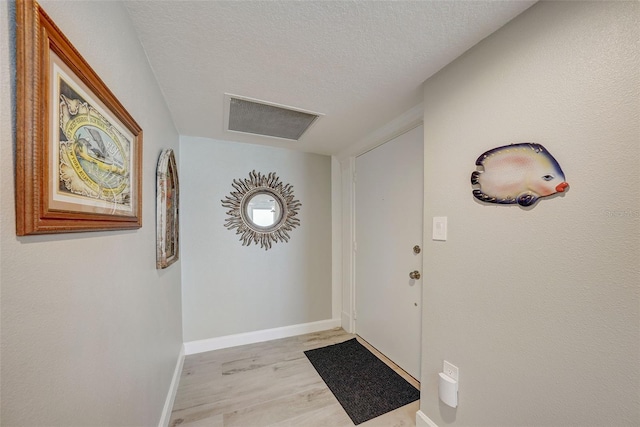 17408 Gulf Blvd Unit 601, Redington Shores, FL 33708 - foyer with light wood-style floors and a textured ceiling