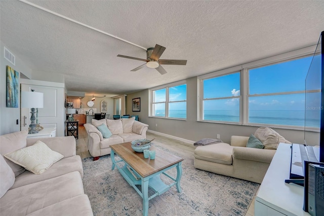 17408 Gulf Blvd Unit 601, Redington Shores, FL 33708 - living area featuring a ceiling fan, a textured ceiling, and wood finished floors