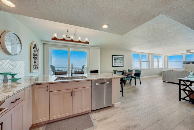 17408 Gulf Blvd Unit 601, Redington Shores, FL 33708 - kitchen featuring stainless steel dishwasher, open floor plan, a textured ceiling, light stone counters, and a chandelier
