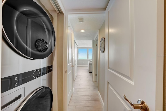17408 Gulf Blvd Unit 601, Redington Shores, FL 33708 - washroom featuring estacked washer and dryer and baseboards