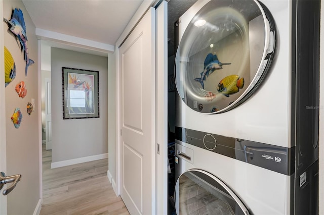 17408 Gulf Blvd Unit 601, Redington Shores, FL 33708 - washroom featuring stacked washer / dryer and light wood-style flooring