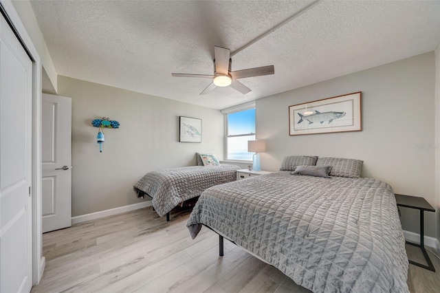 17408 Gulf Blvd Unit 601, Redington Shores, FL 33708 - bedroom with light wood-style flooring, ceiling fan, and a textured ceiling