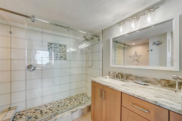 17408 Gulf Blvd Unit 601, Redington Shores, FL 33708 - bathroom with a stall shower, vanity, a textured ceiling, and wood finished floors